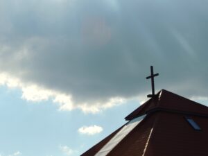 Church cross against a cloud background