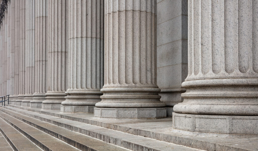 Stone colonnade and stairs detail. Classical pillars row in a building facade