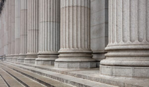Stone colonnade and stairs detail. Classical pillars row in a building facade