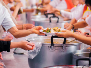 Individuals serving food at a shelter