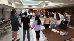 Students holding hands in a circle